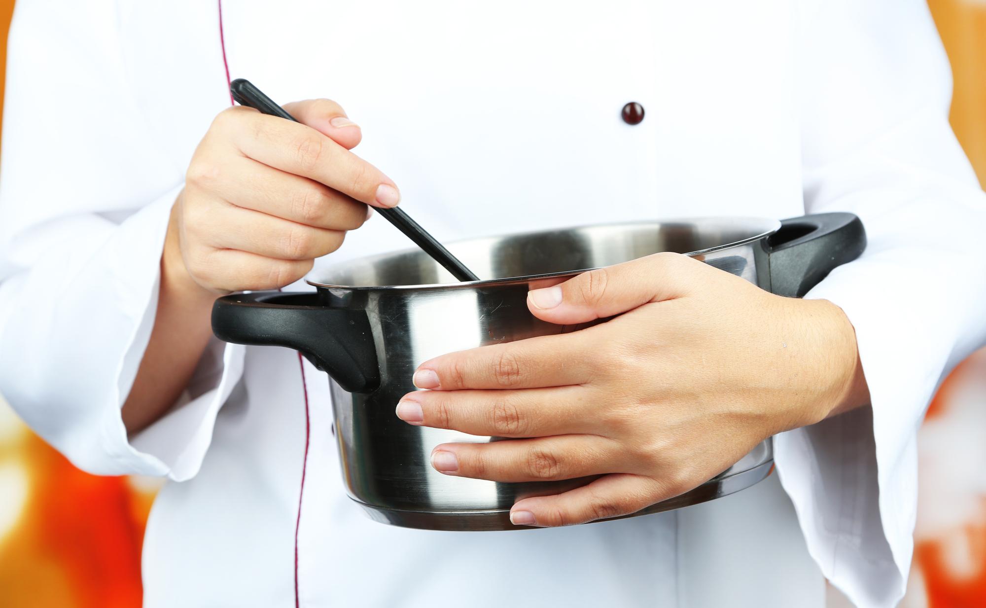 Chef finishing a sauce